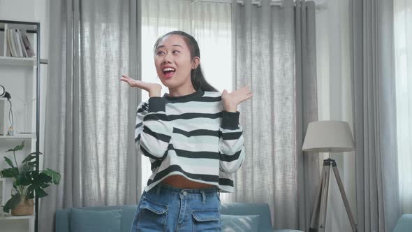 Asian Woman Dancing While Shooting Video Content For Social Networks At Home alt