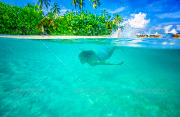 Swimming near tropical island - Stock Photo - Images
