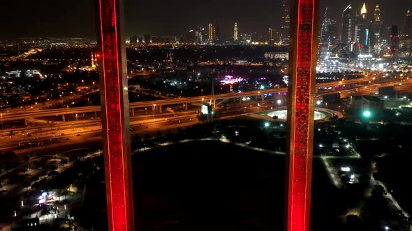 Aerial hyperlapse of the illuminated Dubai Frame at night, U.A.E. alt