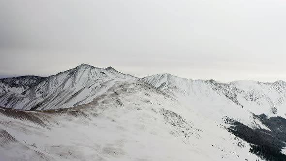  4k view above the Rocky Mountains and snow covered Arapaho and Roosevelt National Forests 