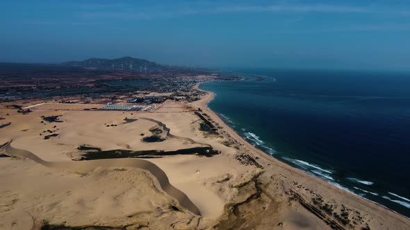 drone fly above Vietnam coastline with Sand dunes beach in Mui dinh. Aerial view of tropical seascap alt