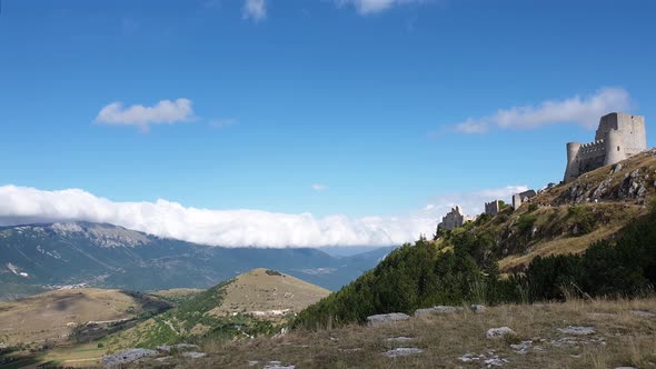 Pan of Rocca Calascio montaintop fortress and Appenines mountain range, Italy alt