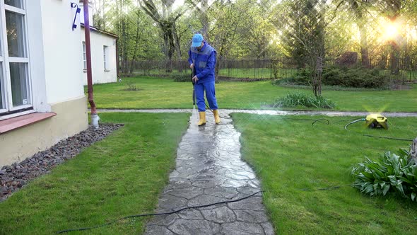 Guy Washing Concrete Path Near His House