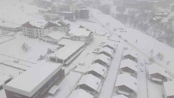 Flying over mountain resort Crystal in Bakuriani. Snowy winter day. Georgia alt