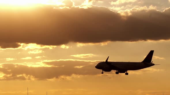 Airplane approach to landing at sunset