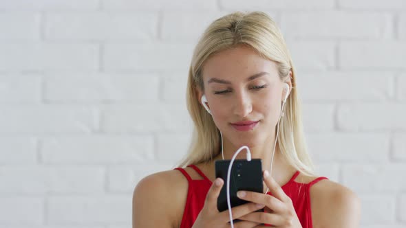 Cute Female Listening To Music and Using Smartphone alt