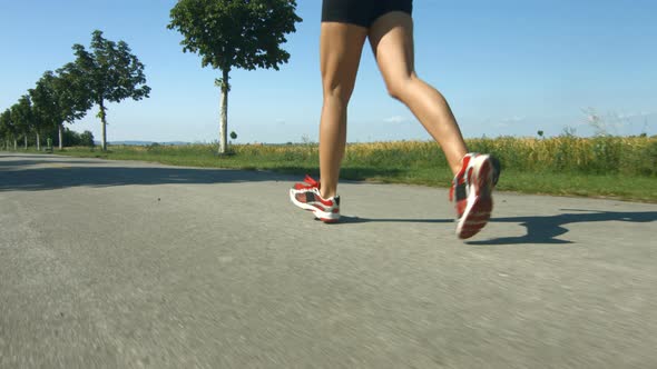 Woman Running on Road – Legs Only