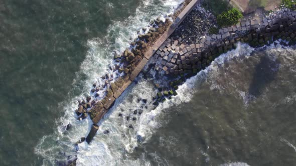 Aerial View Of The Waves Crashing The Rocks