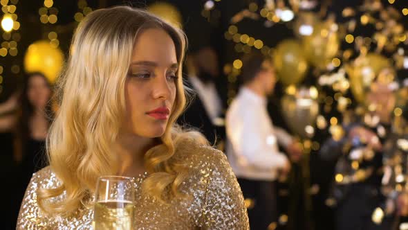 Sad Blond Woman Feeling Lonely at Party, Dancing People on Background, Offence alt