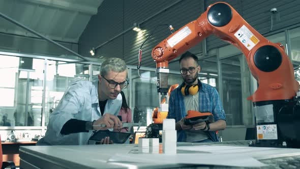 Young Electronics Engineers Studing Robotics in the High-school Laboratory. Young Scientists Are alt