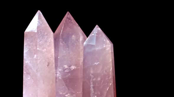 Three Rose Quartz and Crystal on Rotates on a Black Background alt