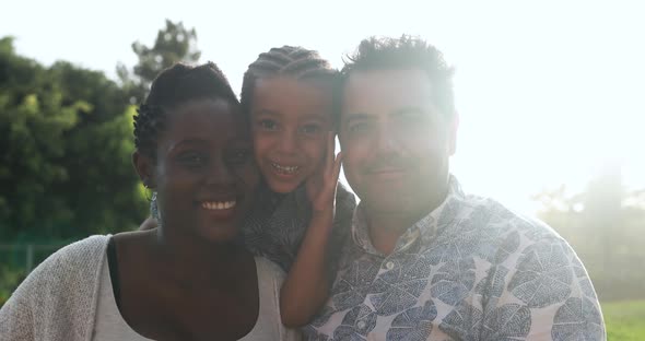 Happy multiracial family having playful time at park - Family love alt