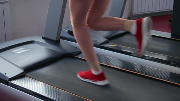 Young woman training on treadmill