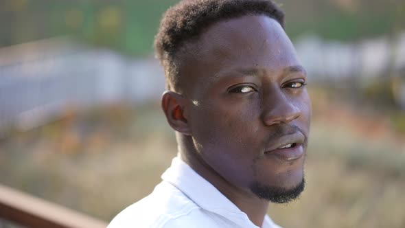 Closeup Young Handsome Man Posing Outdoors in Urban City Park alt