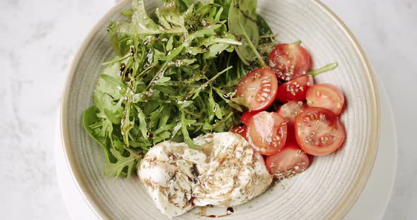 Tasty Salad in a White Plate on a White Background alt