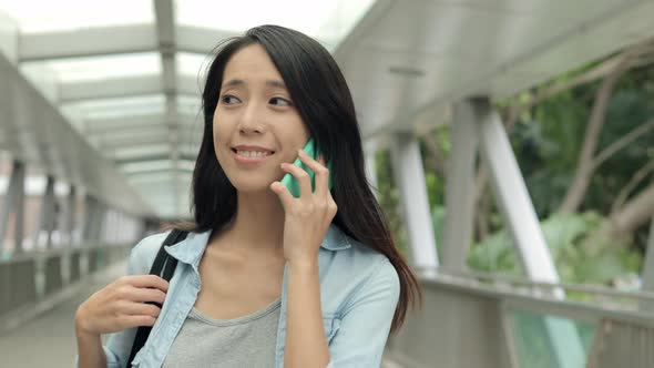 Woman using mobile phone at street alt