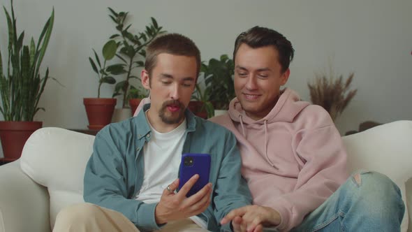 Two Young Lgbt Men are Talking with Their Friends on the Video Call Listening Attentively and alt