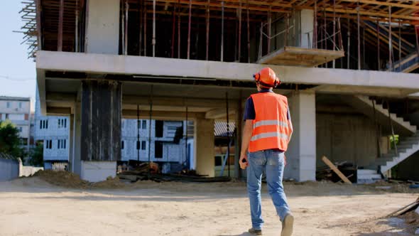 At Big Construction Site Walking Foreman in a alt