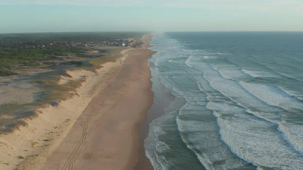 Endless Shore Line with Small Beach Town Lacanau in France at Sunset, Aerial Establishing Wide Shot alt