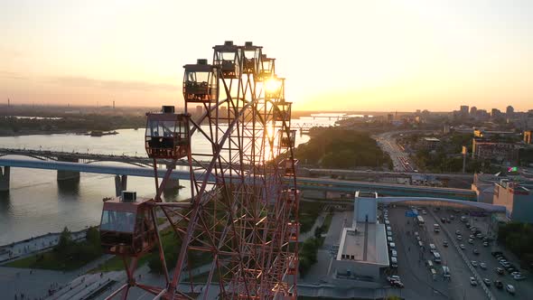 Drone View Colorful Ferris Wheel in Amusement Park on River and City Landscape