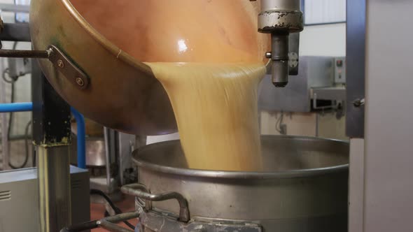 Mixing ingredients for chocolate fudge at candy factory