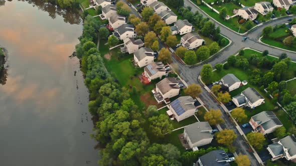 Aerial top view waterfront suburban street of middle class suburban neighborhood with houses alt