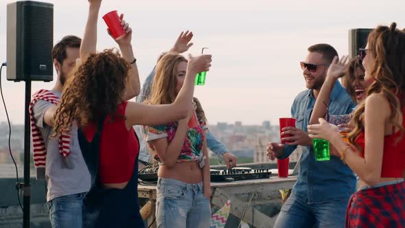 Diverse Friends Partying on Rooftop at Daytime alt