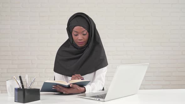 African Woman Reading Notes