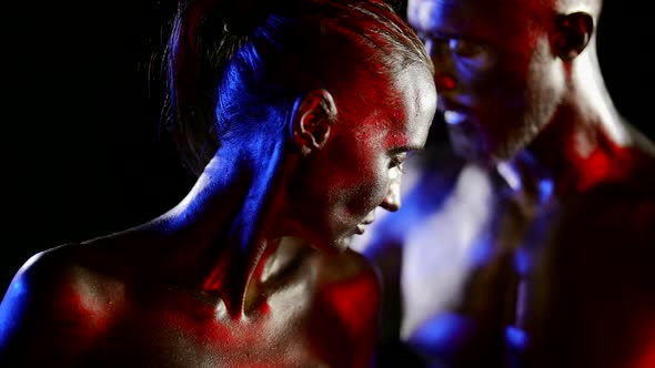 Closeup of a Female Profile with Golden Metallic Skin on a Black Background alt