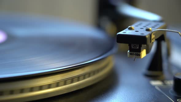 The Vinyl Record on DJ Turntable Record Player Close Up. The Rotating Plate and Stylus with the