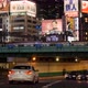 Night View of Busy Tokyo Road in Shinjuku with Lit Up Neon Advertising Screens - VideoHive Item for Sale