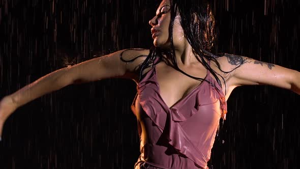 Beautiful Sexy Brunette Posing in a Wet Dress and Creates a Spray of Hair alt