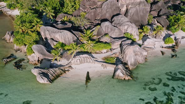 Aerial Hover Down Footage of Well Known Anse Source d'Argent Tropical Beach at Sunny Day Bright