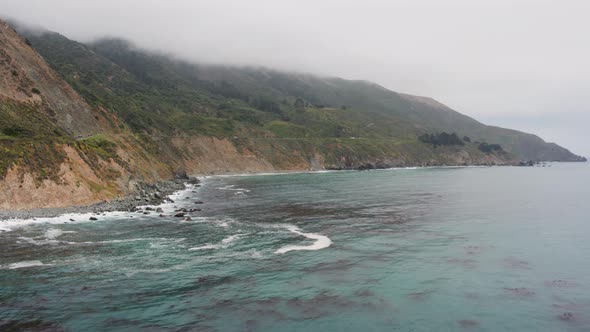 Aerial Drone Shot Ascending to Reveal a Road on Steep Coastline (Big Sur, Pacific Coast Highway, CA)