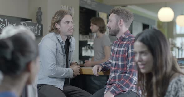 Men sitting and talking in pub