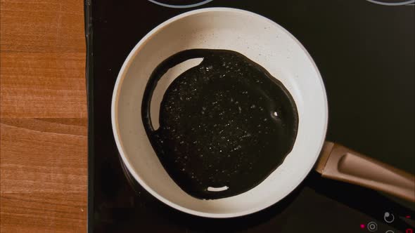 Black Oil on a White Frying Pan