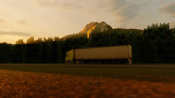 Freight Truck Moving On Rocky Road In Mountainous Area At Sunset