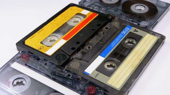 Four Audio Cassettes Rotate on White Background alt