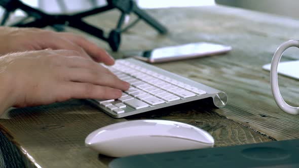 A Caucasian Male Typing on a Wireless Keyboard 10 alt