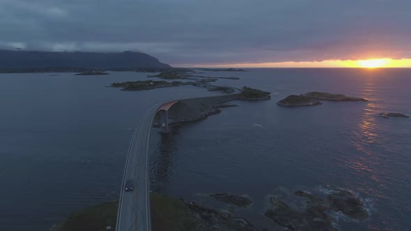 Atlantic Ocean Road in Norway and Cars at Summer Sunset alt