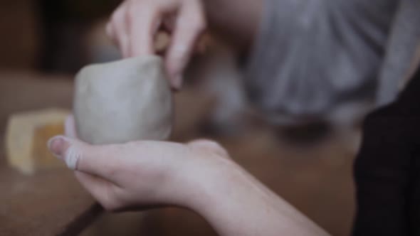 Close-up of female potter working with clay alt