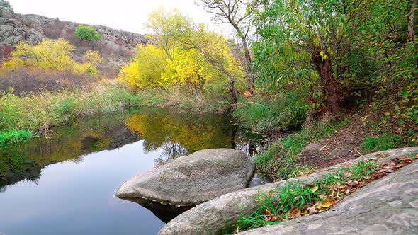 A Fast Clean Stream Runs Among Smooth Wet Stones Surrounded By Tall Dry Lumps alt