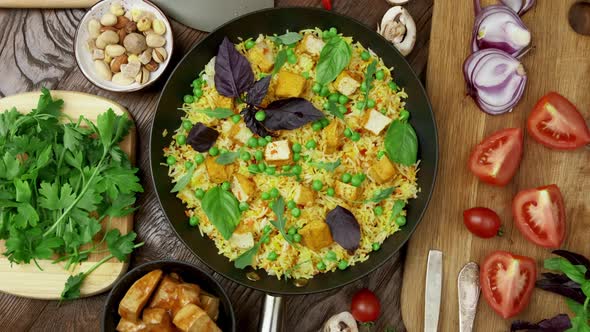 Vegetable Rice with Green Peas Carrots Tofu and Mushrooms on Wooden Background alt