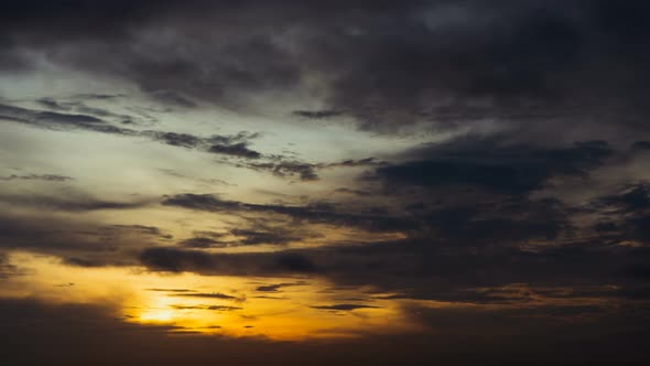 Time lapse sunset sunrise and beautiful twilight fluffy storm cloudy blue and yellow sky alt
