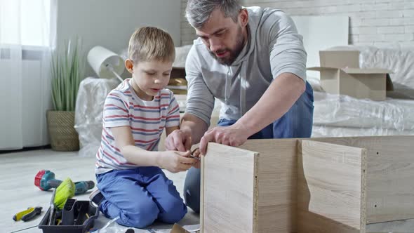 Father Teaching Son to Assemble Furniture alt