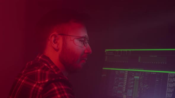 A Caucasian Man in Glasses Works on the Computer Inputs Code Types Very Fast on the Keyboard Checks alt