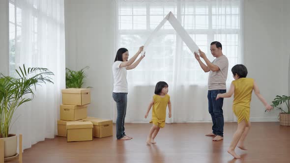 Asian happy family doing activities together in the living room