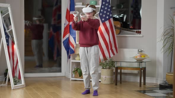 Happy Relaxed Woman in VR Headset Playing at Home in the Evening Smiling alt