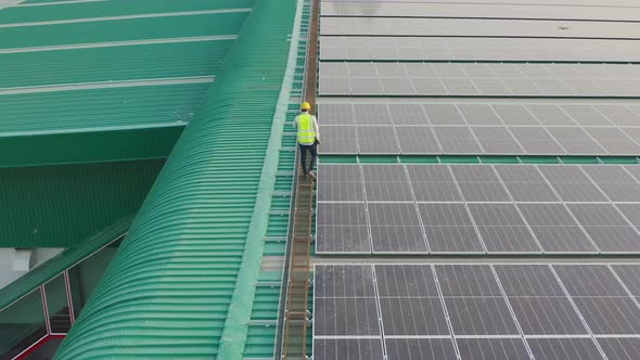 Aerial top view of engineer man or worker,people, with solar panels or solar cells on the roof alt