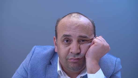 Bald man taking off wig. alt